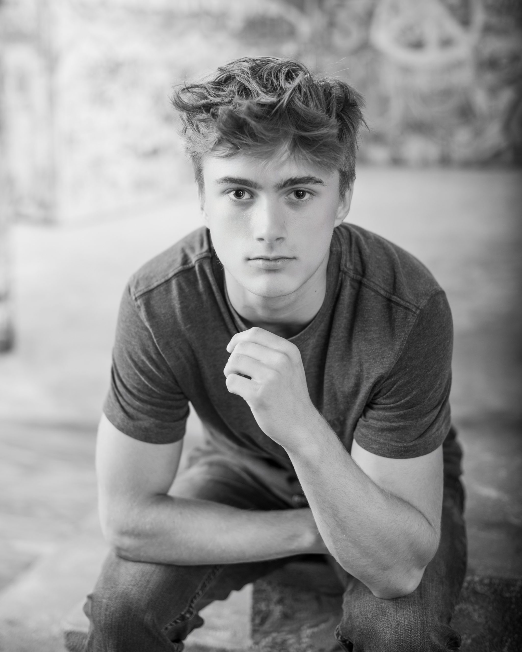 Senior portrait with football in studio setting | Studio ONE Photography