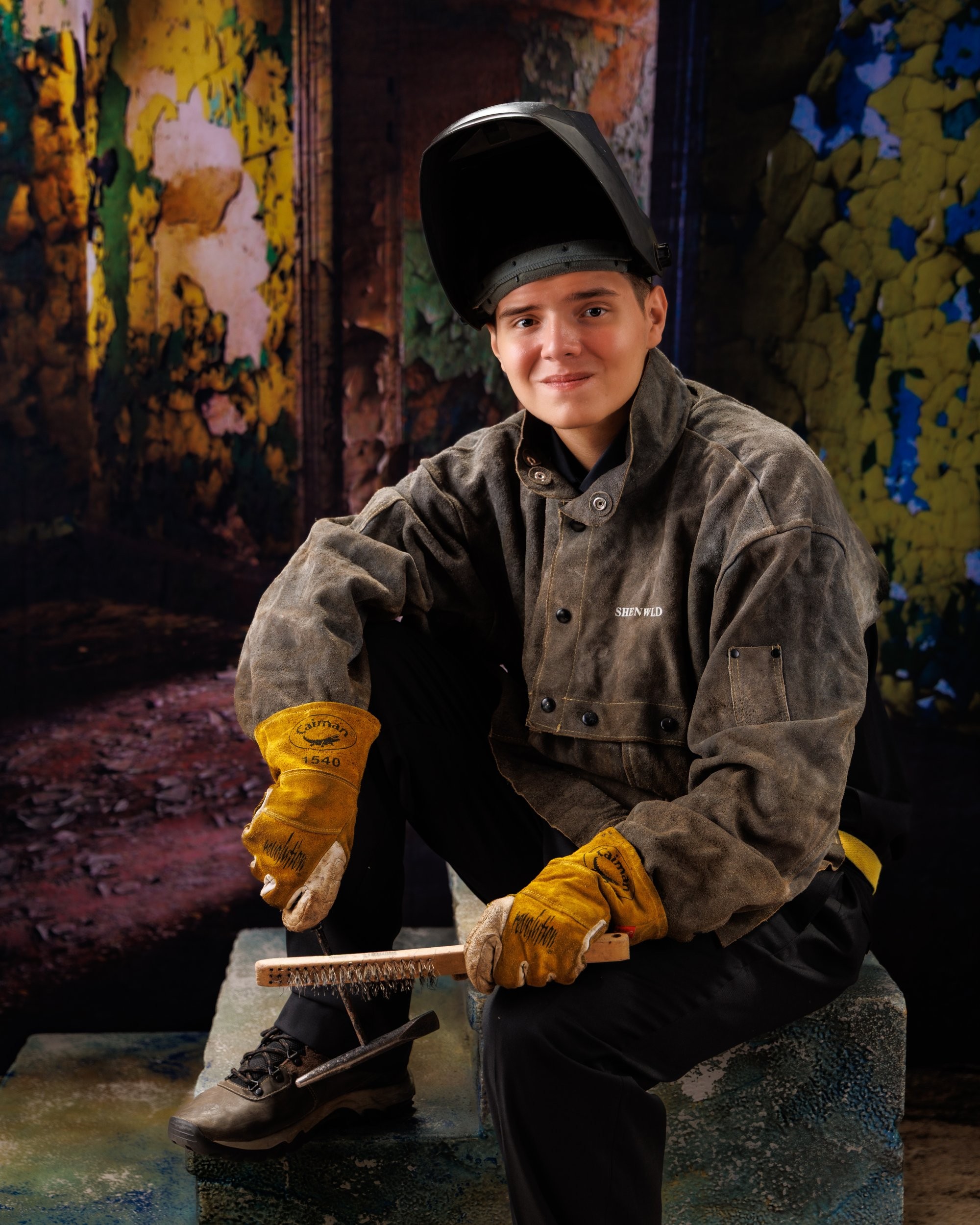 Creative Trenton senior portrait incorporating welding gear and industrial elements to highlight Downriver photography's artistic style