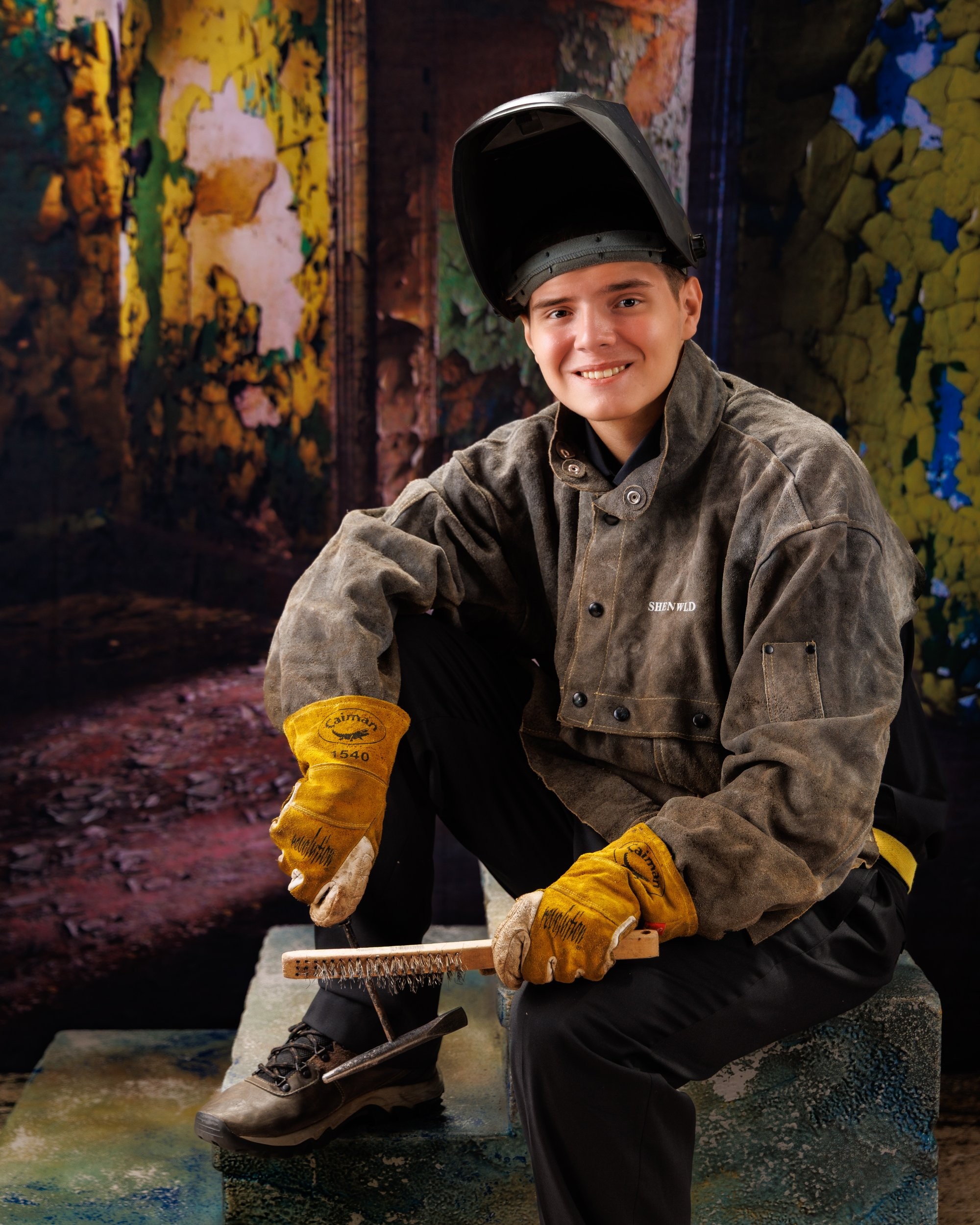 Creative Trenton senior portrait incorporating welding gear and industrial elements to highlight Downriver photography's artistic style