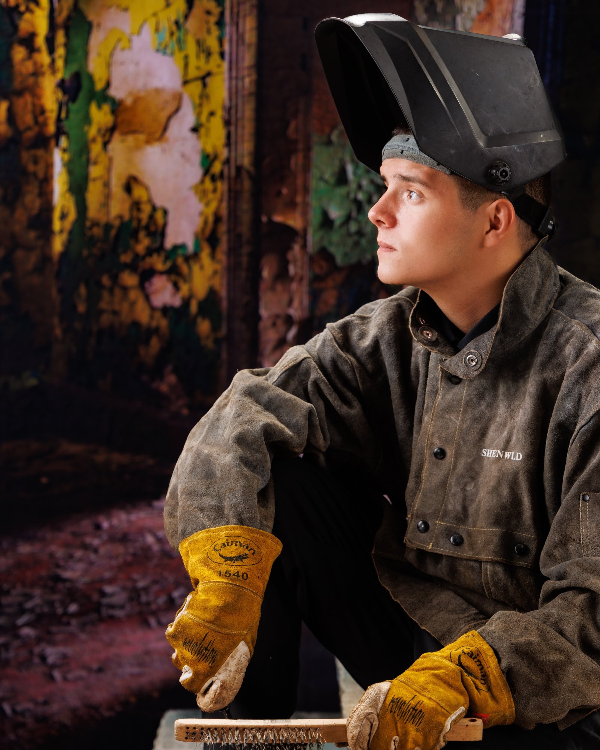 Creative Trenton senior portrait incorporating welding gear and industrial elements to highlight Downriver photography's artistic style