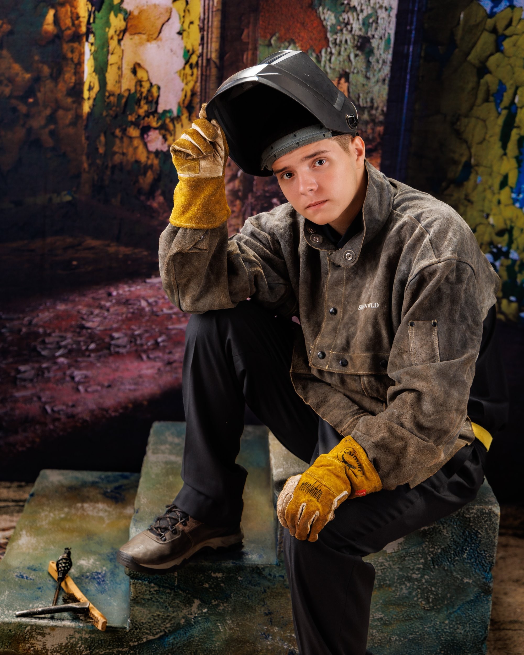 Creative Trenton senior portrait incorporating welding gear and industrial elements to highlight Downriver photography's artistic style