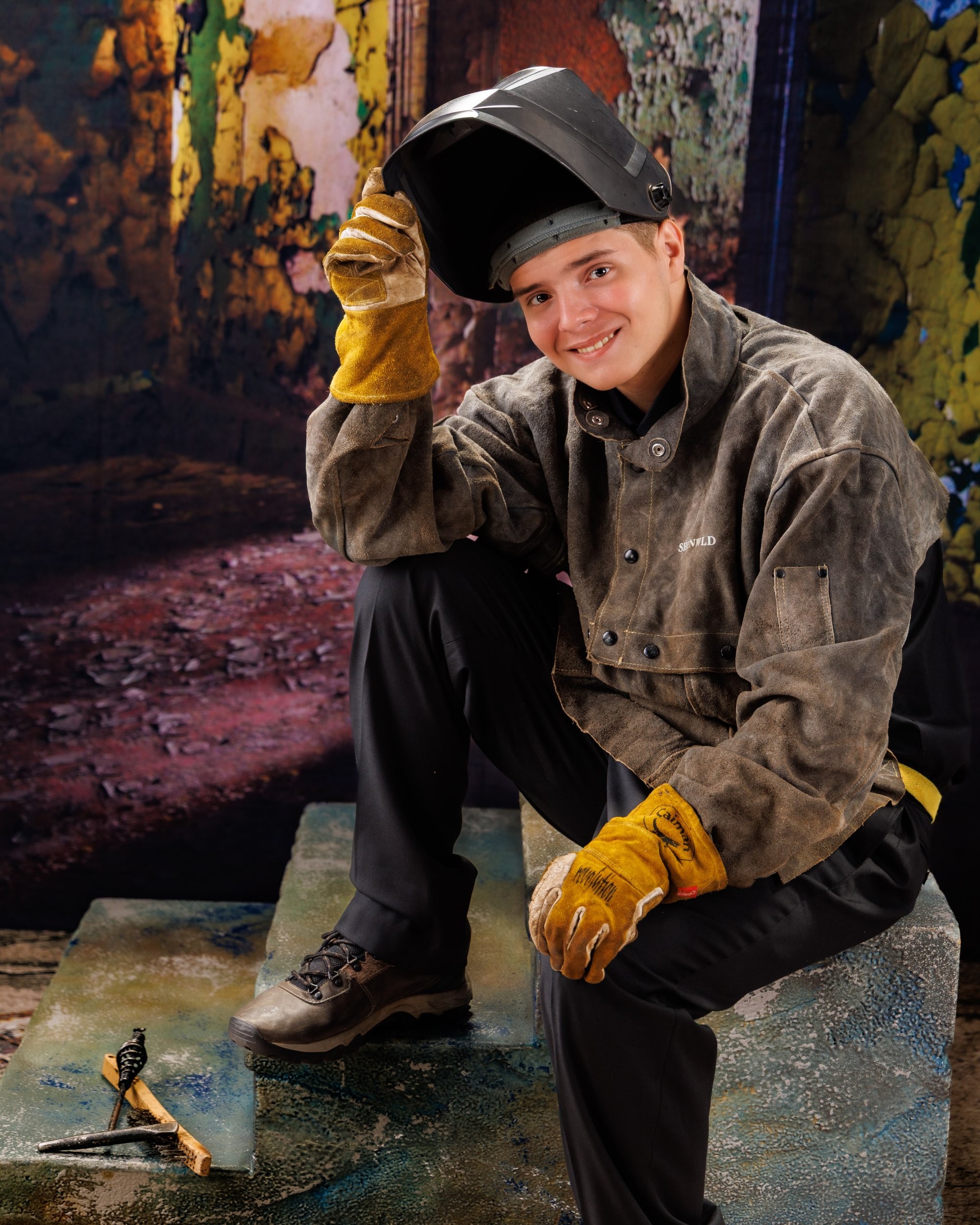 Creative Trenton senior portrait incorporating welding gear and industrial elements to highlight Downriver photography's artistic style