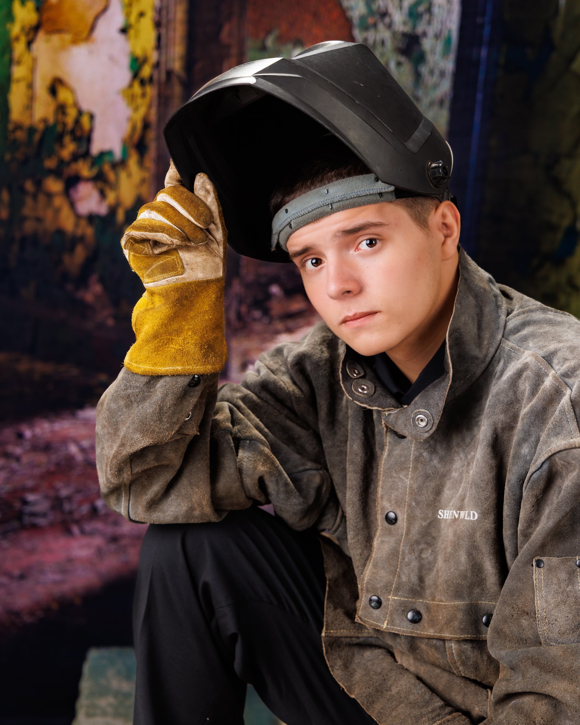 Creative Trenton senior portrait incorporating welding gear and industrial elements to highlight Downriver photography's artistic style