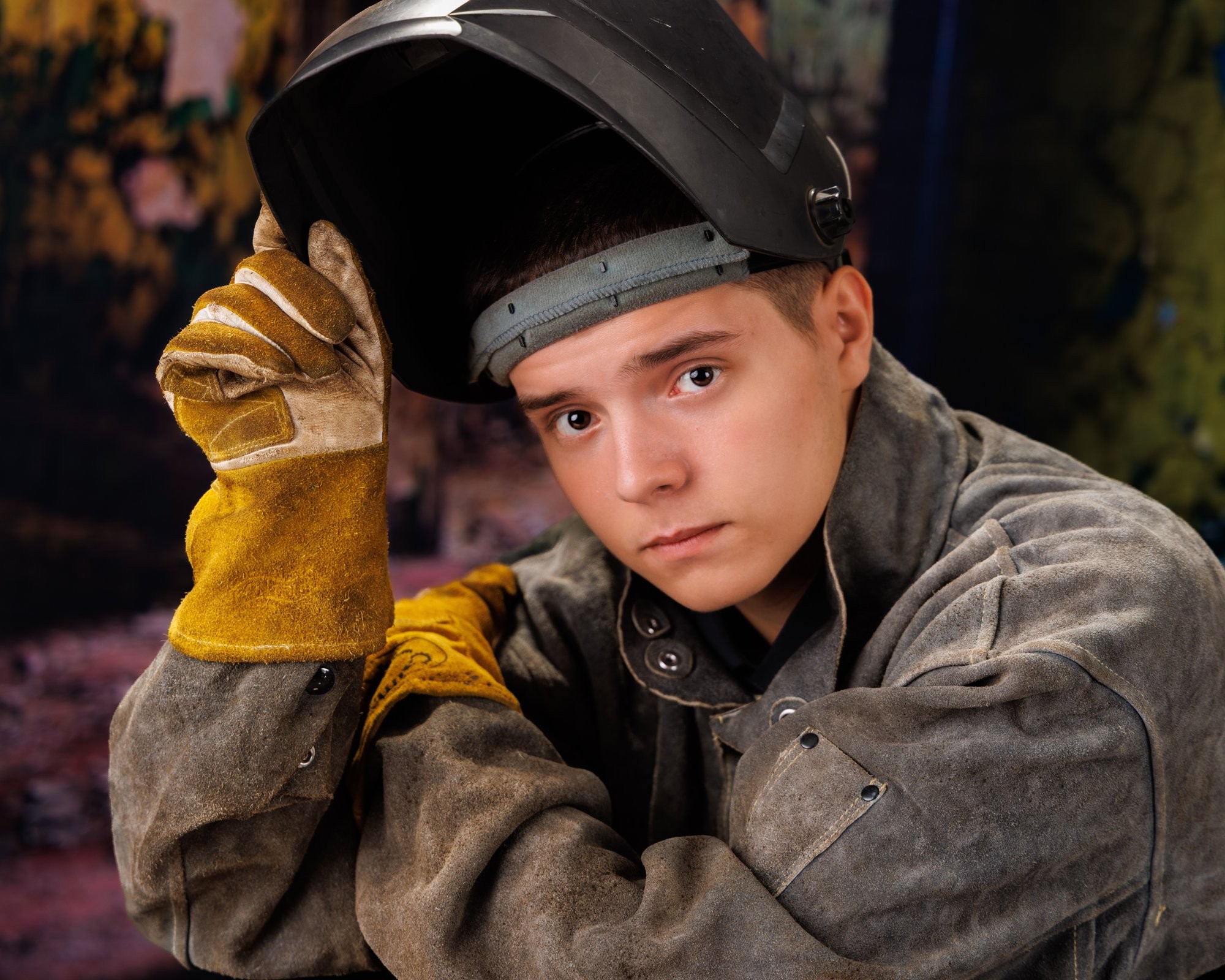 Creative Trenton senior portrait incorporating welding gear and industrial elements to highlight Downriver photography's artistic style