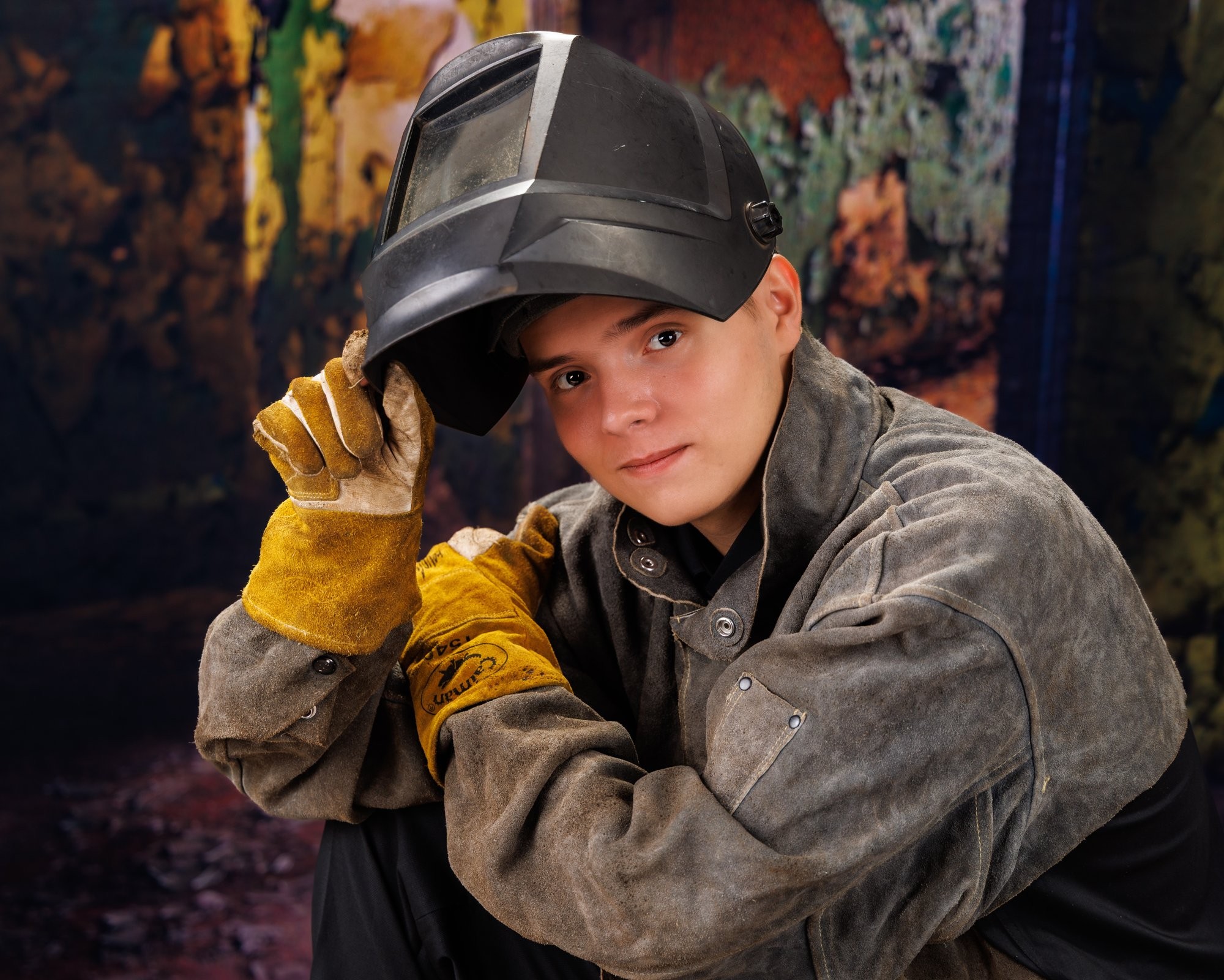 Creative Trenton senior portrait incorporating welding gear and industrial elements to highlight Downriver photography's artistic style