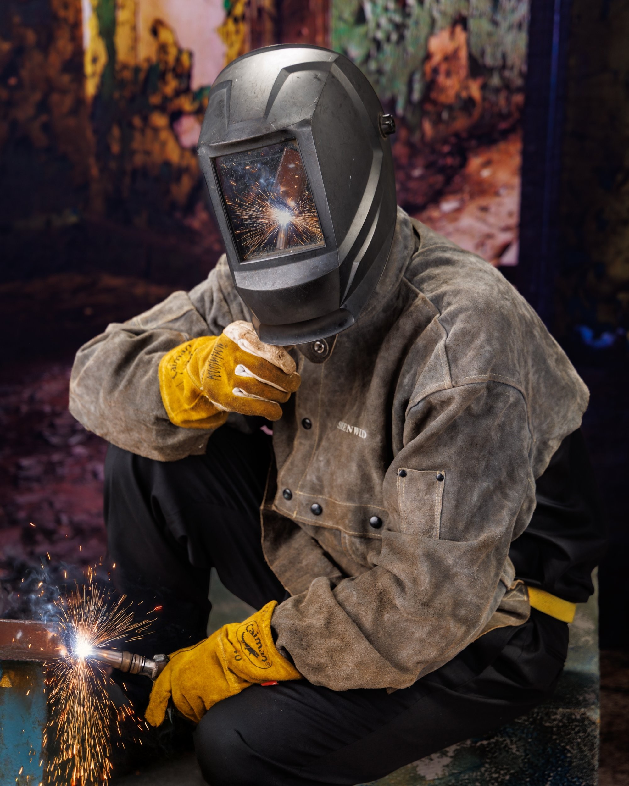 Creative Trenton senior portrait incorporating welding gear and industrial elements to highlight Downriver photography's artistic style
