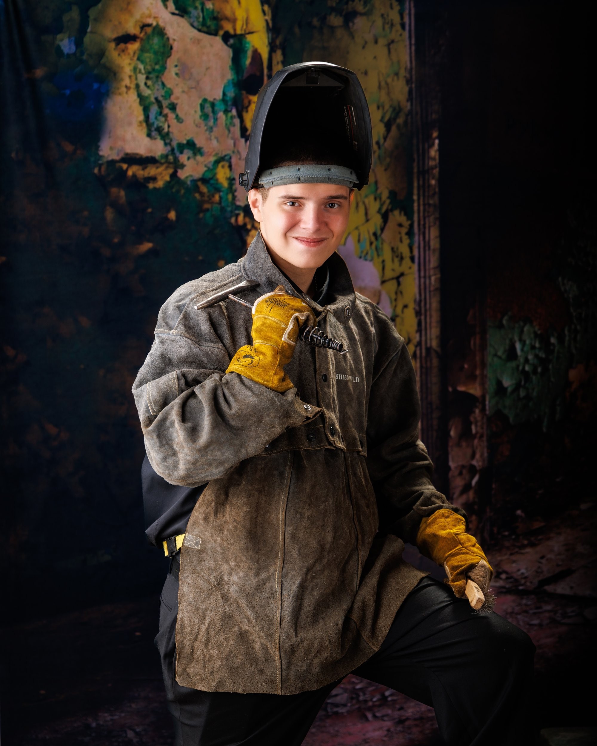 Creative Trenton senior portrait incorporating welding gear and industrial elements to highlight Downriver photography's artistic style