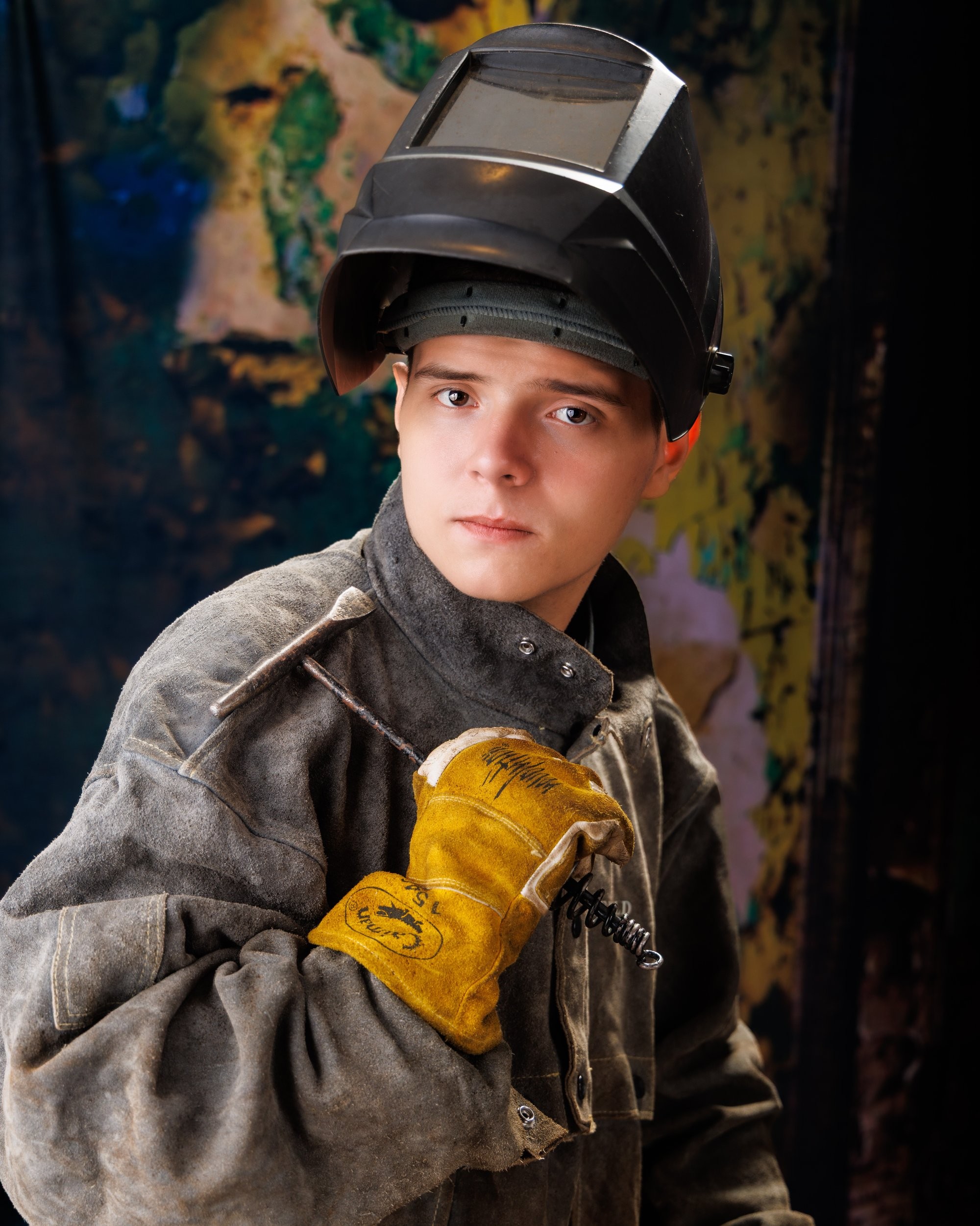 Creative Trenton senior portrait incorporating welding gear and industrial elements to highlight Downriver photography's artistic style