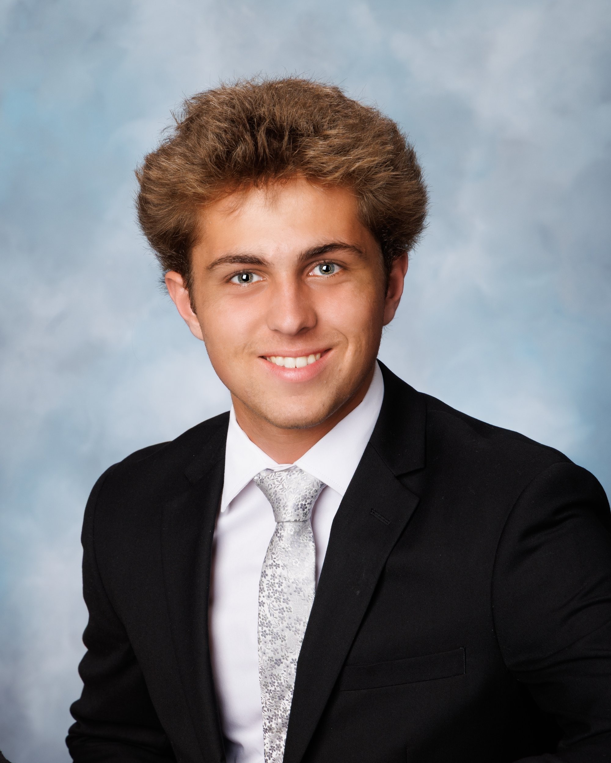 Zack holding hockey stick during a Downriver senior photography session