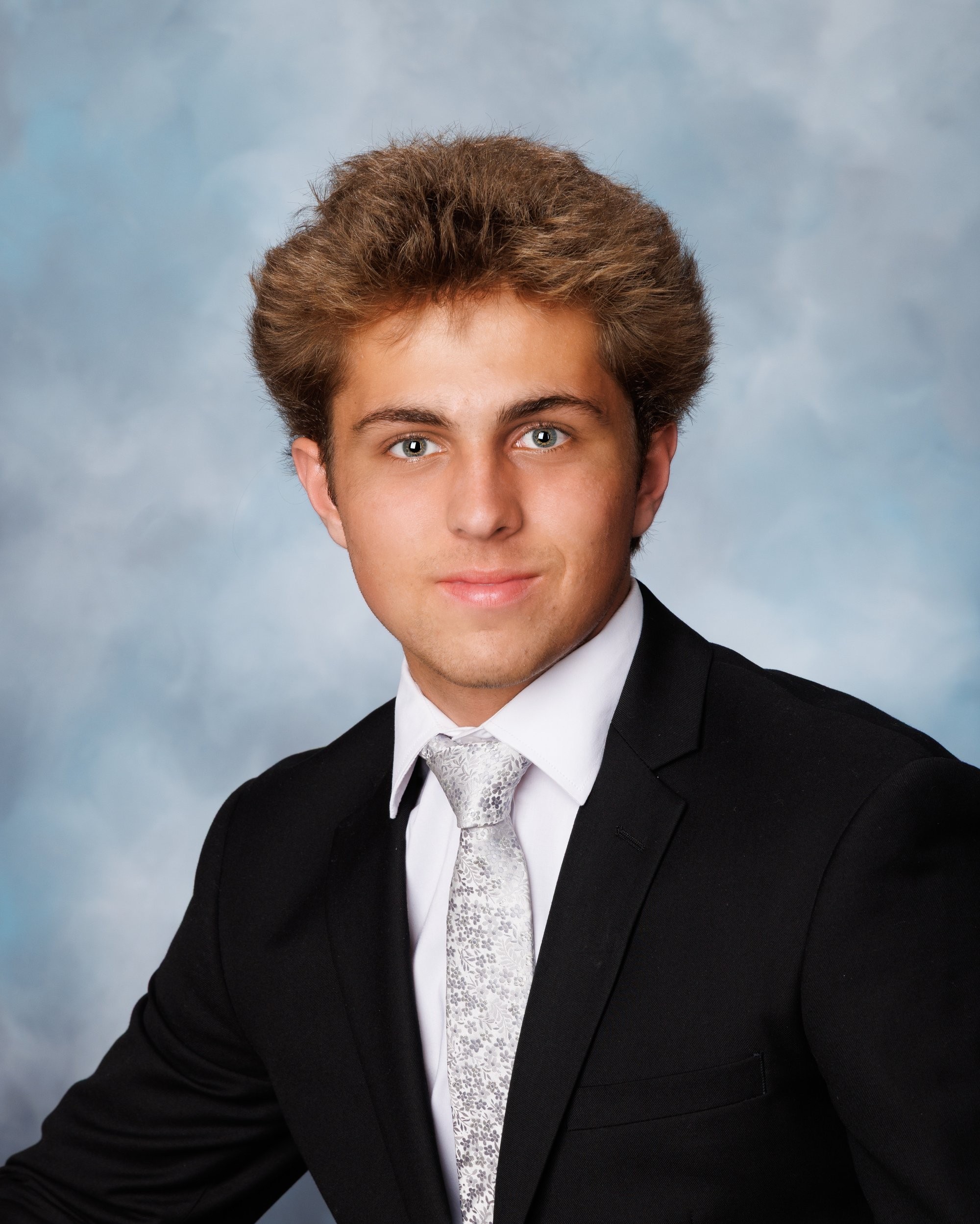 Senior photo of Zack with baseball bat and '2026' text in Trenton photo studio
