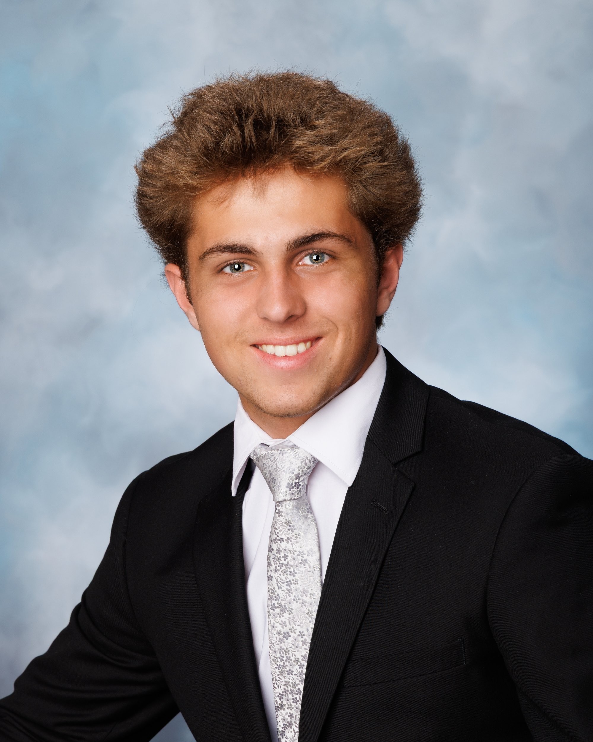 Senior photo of Zack with baseball bat and '2026' text in Trenton photo studio