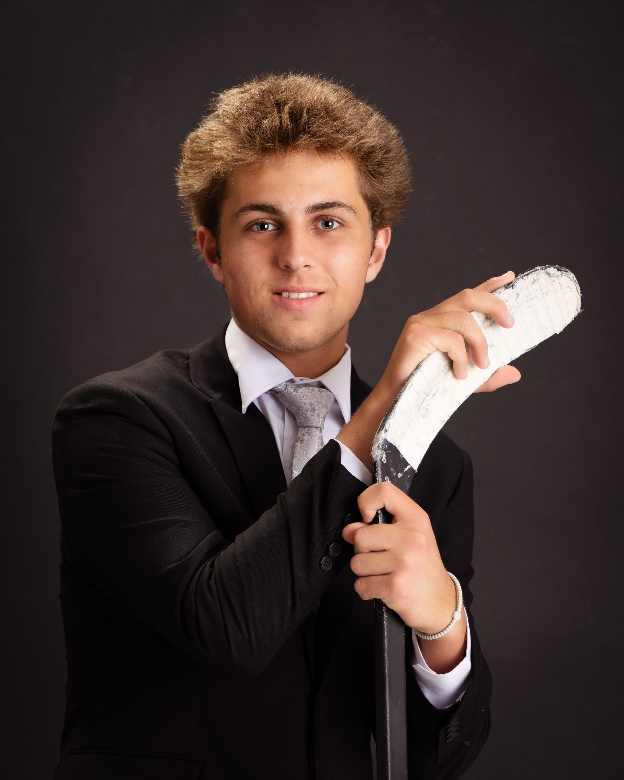Senior photo of Zack with baseball bat and '2026' text in Trenton photo studio