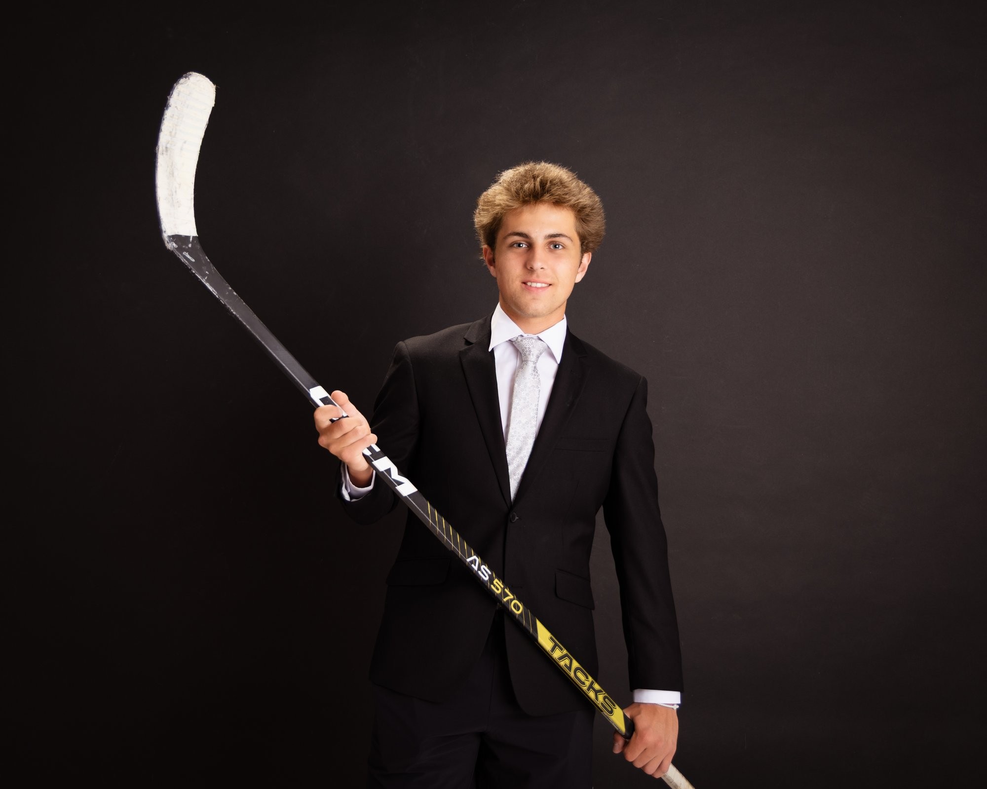 Senior photo of Zack with baseball bat and '2026' text in Trenton photo studio