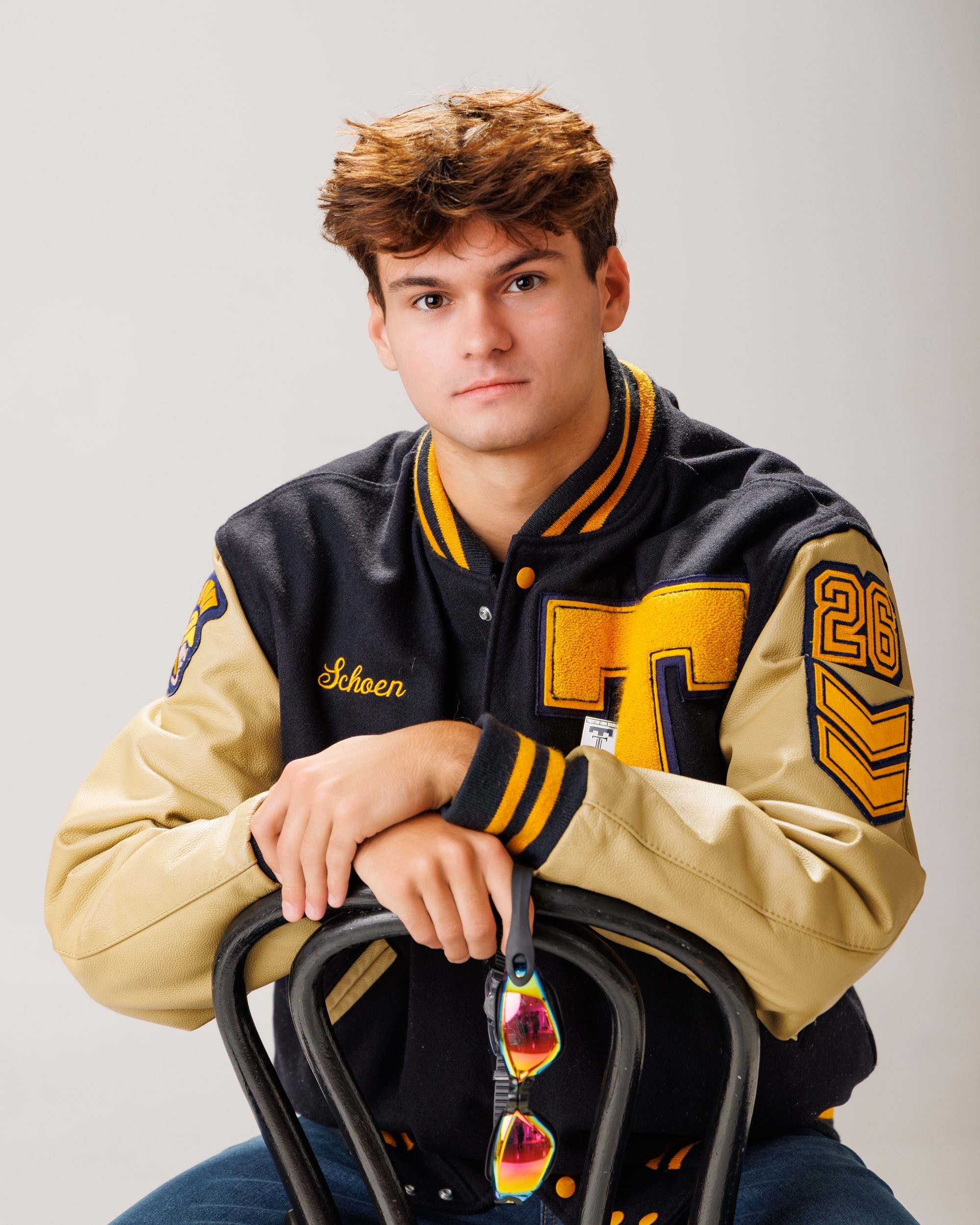 Zachary’s casual senior photo shoot with striped polo and vintage luggage in Trenton setting