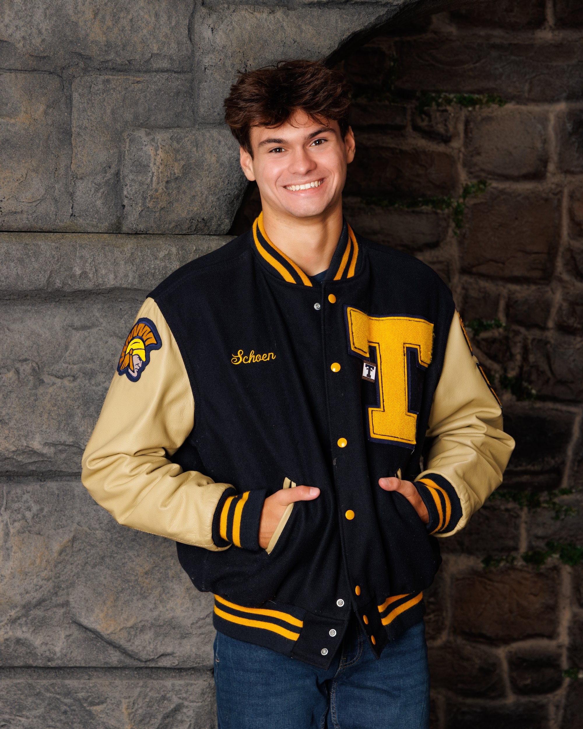 Zachary’s casual senior photo shoot with striped polo and vintage luggage in Trenton setting
