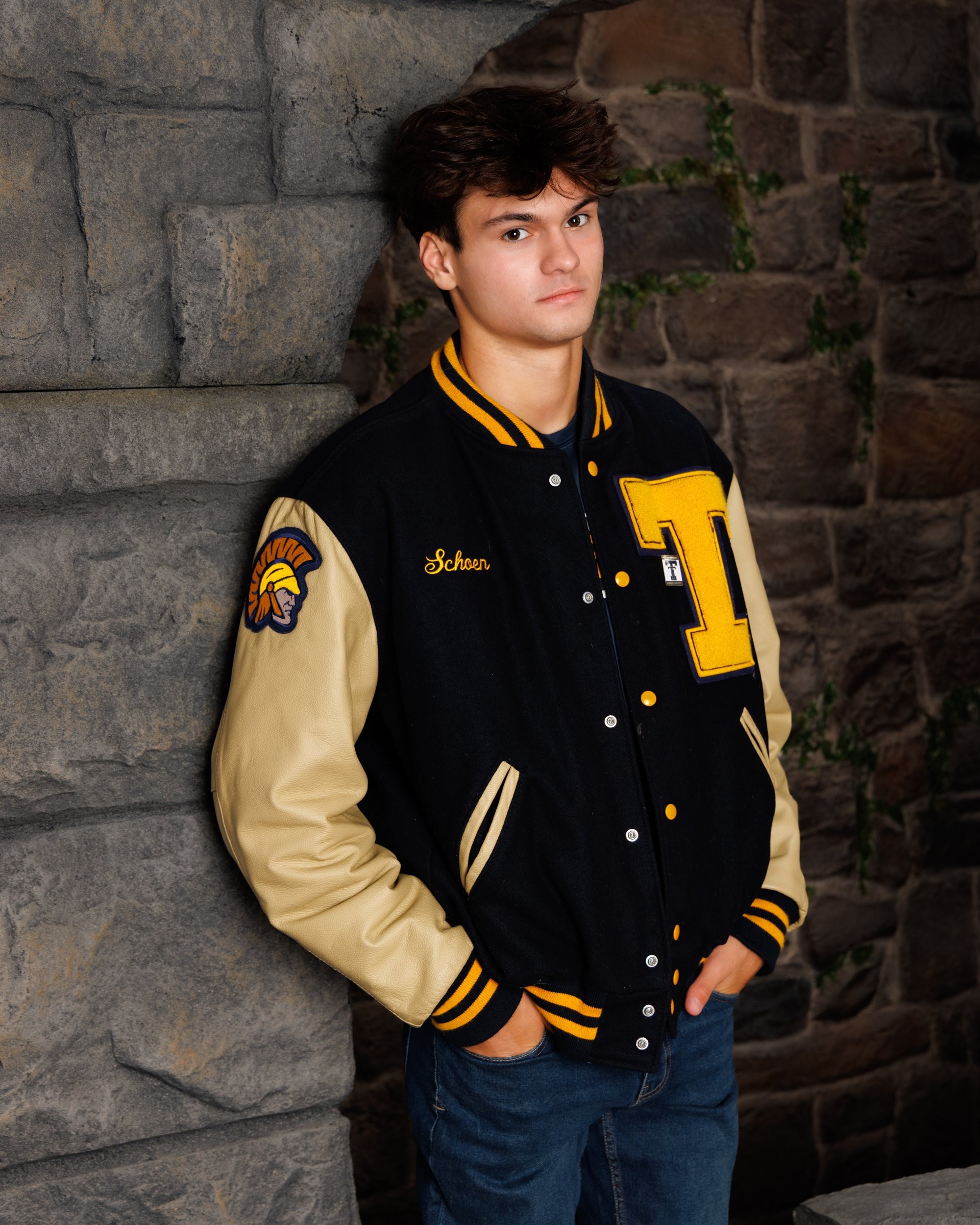 Zachary’s casual senior photo shoot with striped polo and vintage luggage in Trenton setting
