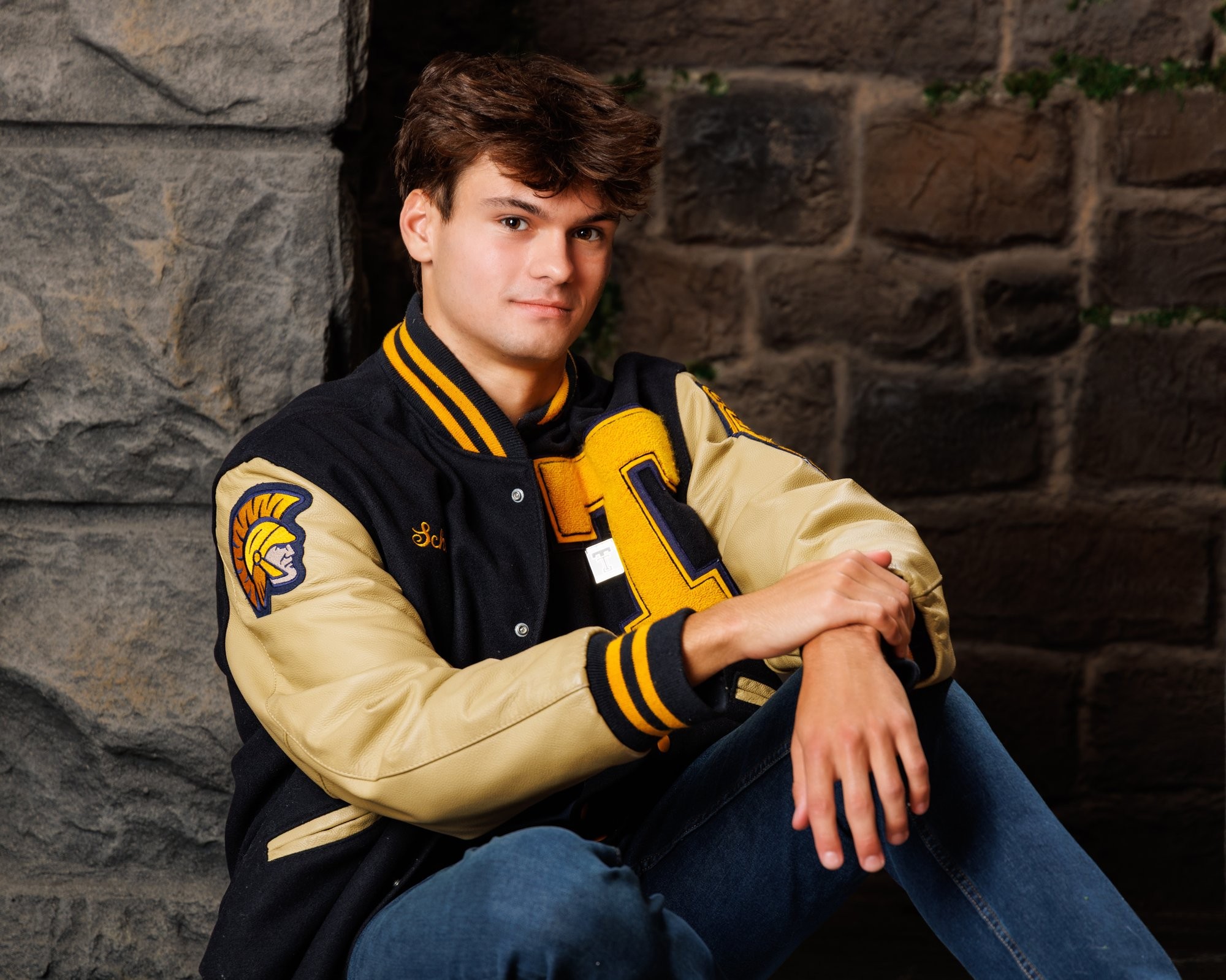 Zachary’s casual senior photo shoot with striped polo and vintage luggage in Trenton setting
