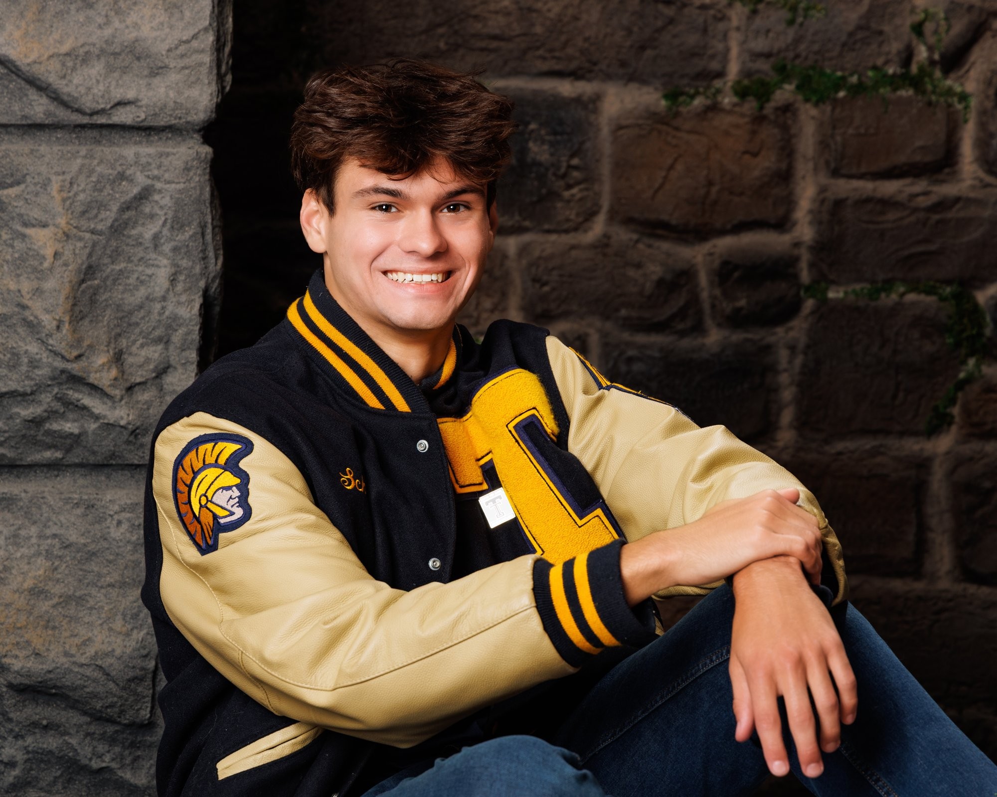 Zachary’s casual senior photo shoot with striped polo and vintage luggage in Trenton setting