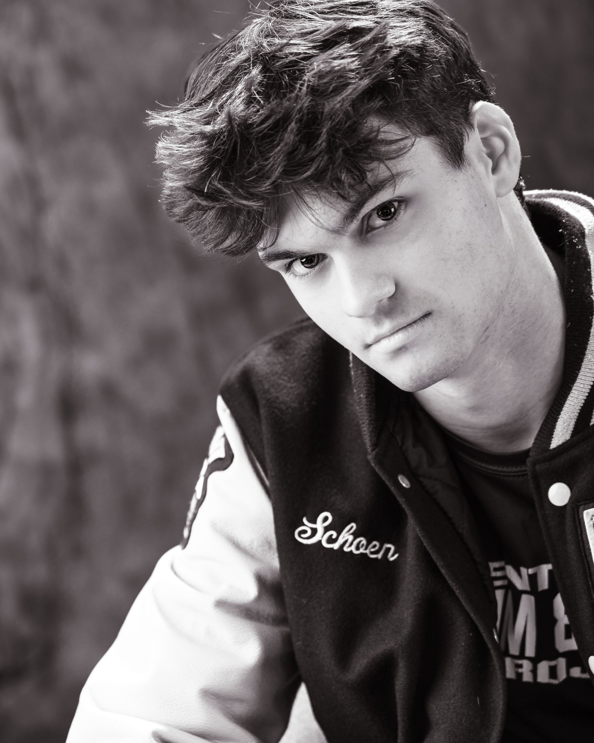 Zachary’s casual senior photo shoot with striped polo and vintage luggage in Trenton setting