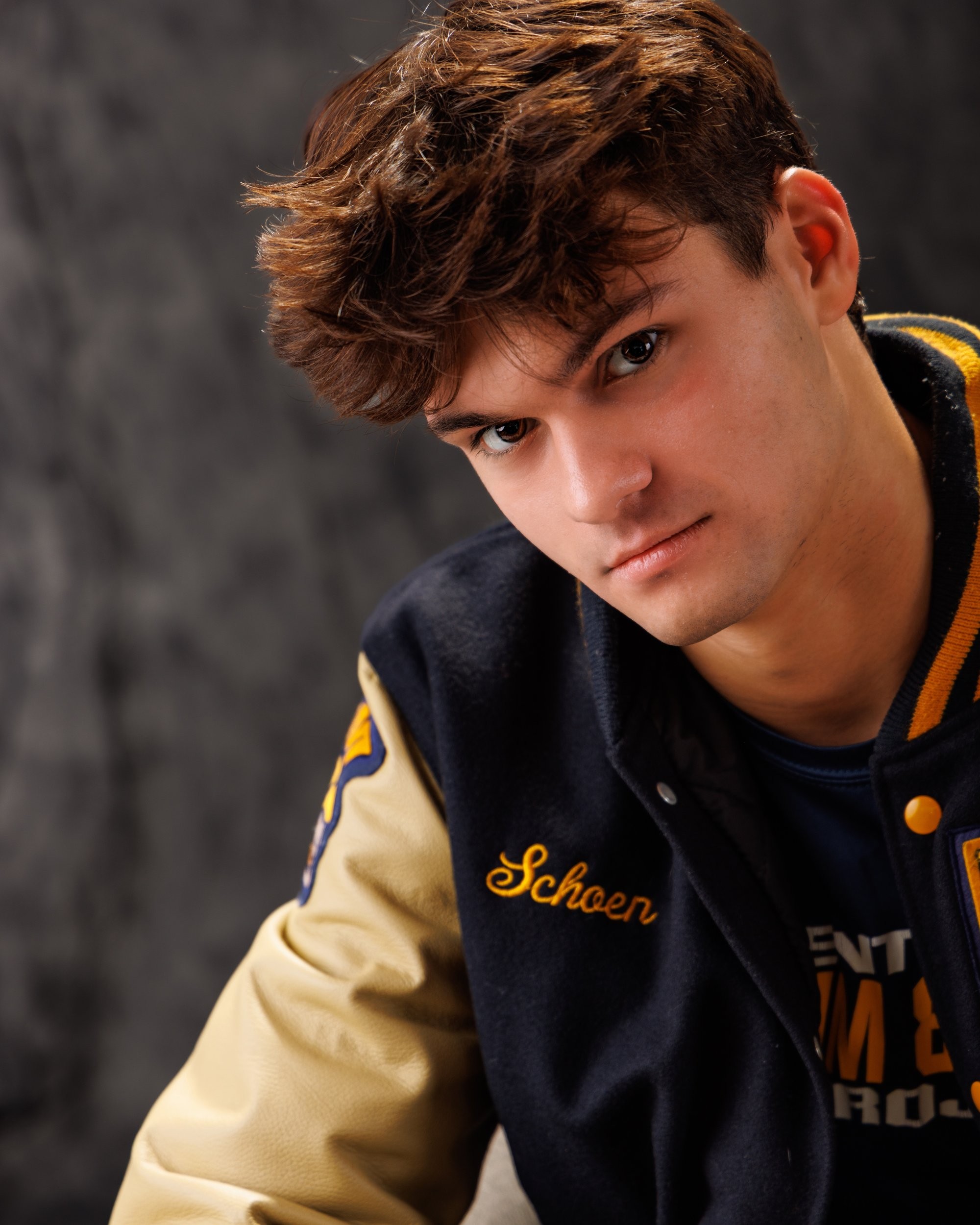 Zachary’s casual senior photo shoot with striped polo and vintage luggage in Trenton setting