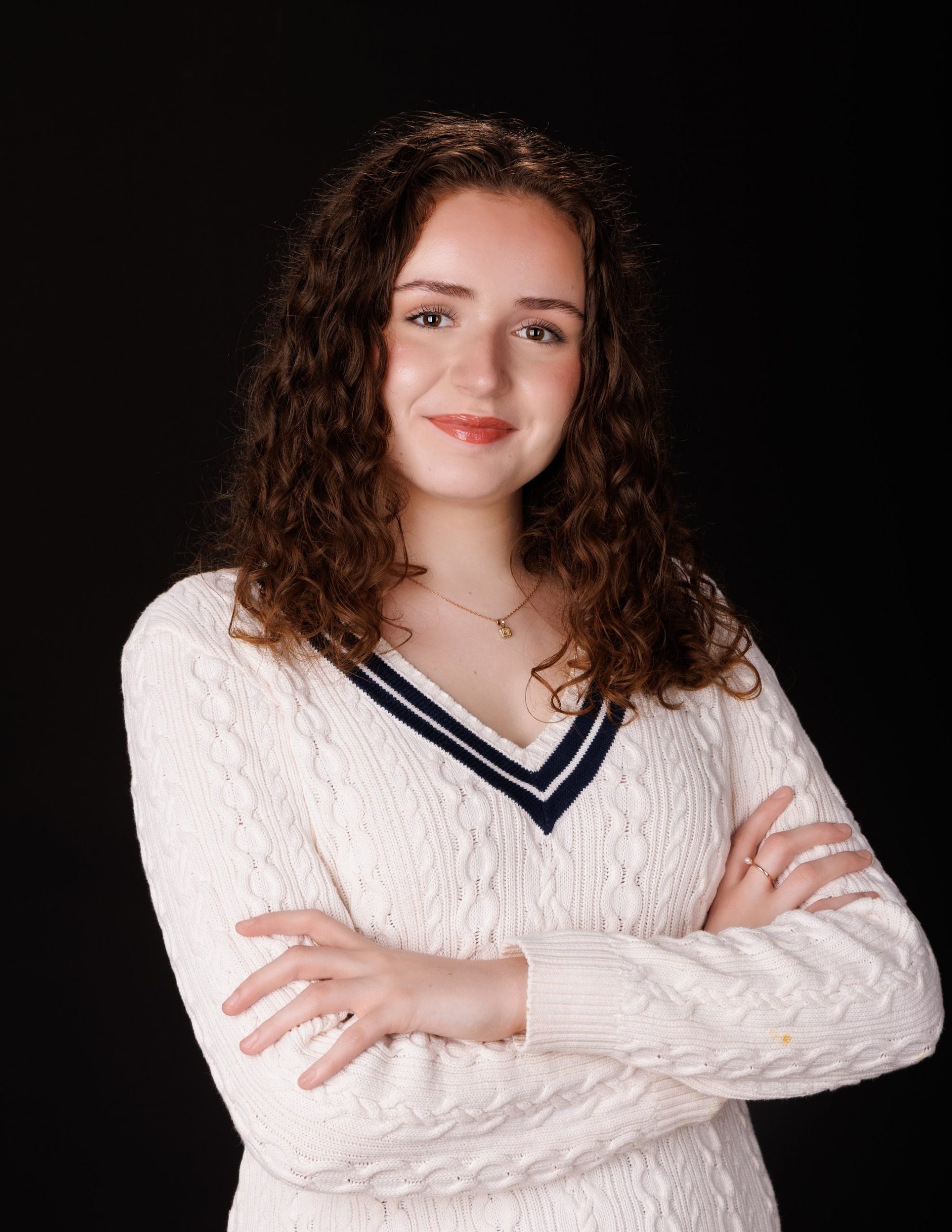 Viona's vibrant background senior portrait with confident expression and school-themed elements
