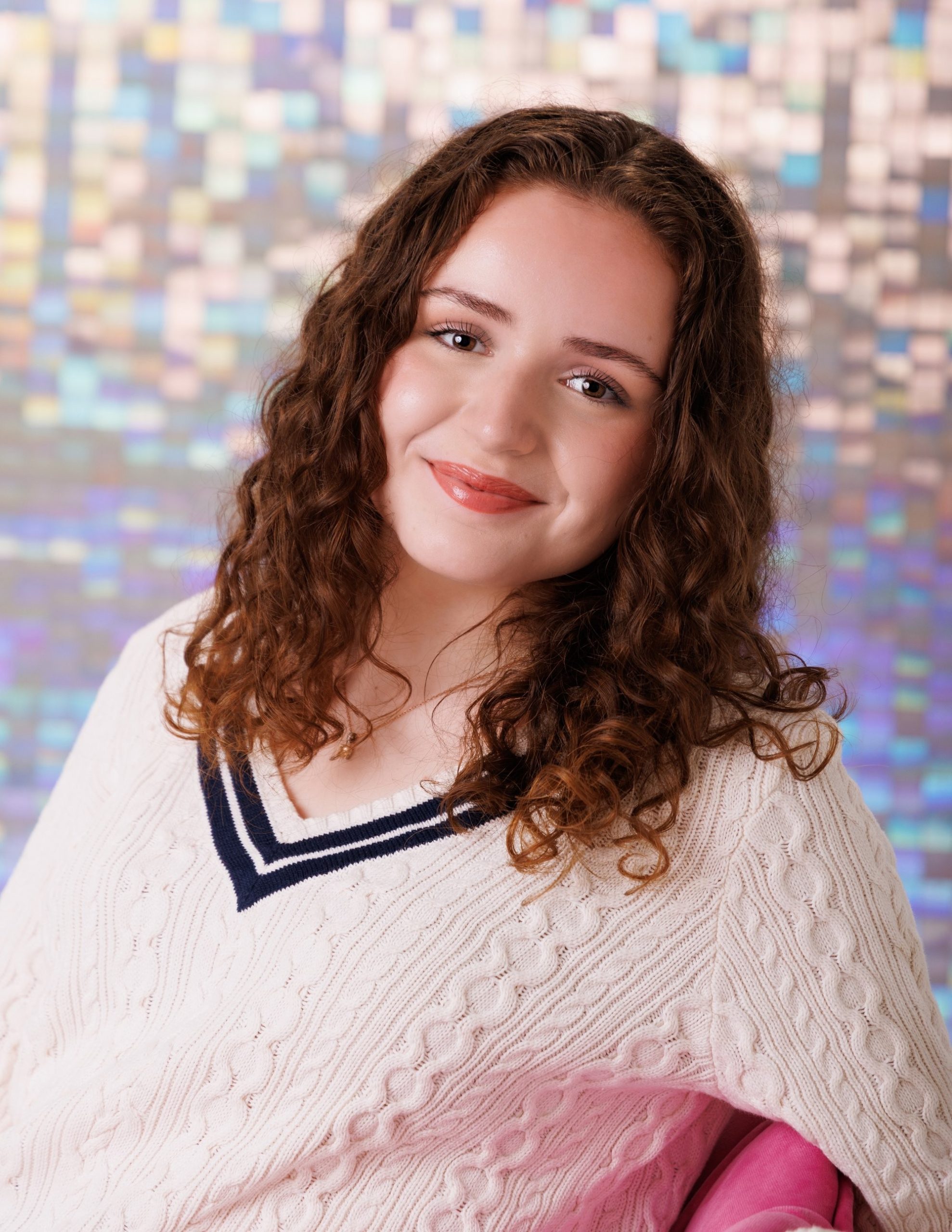 Viona's vibrant background senior portrait with confident expression and school-themed elements