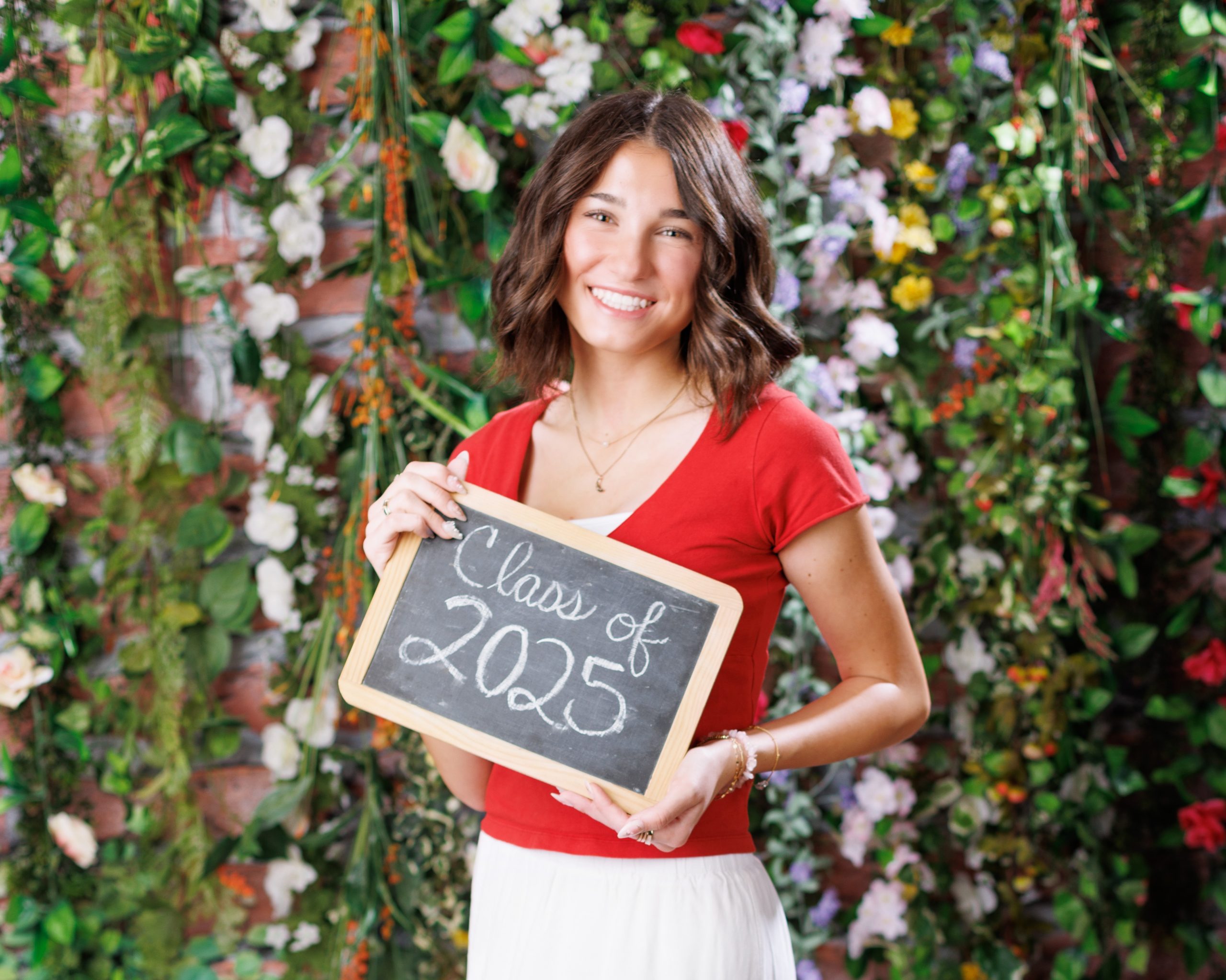 Anna posing in smocked peplum top with arched doorway backdrop at Woodhaven Senior Session