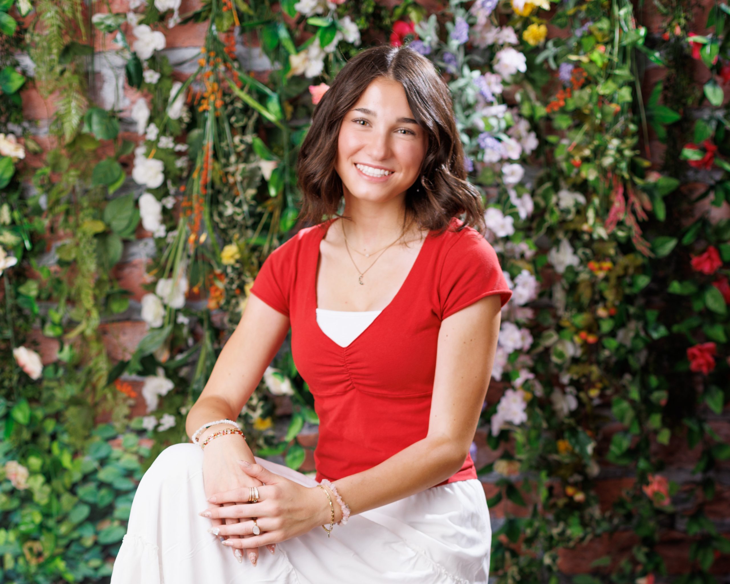 Anna posing in smocked peplum top with arched doorway backdrop at Woodhaven Senior Session