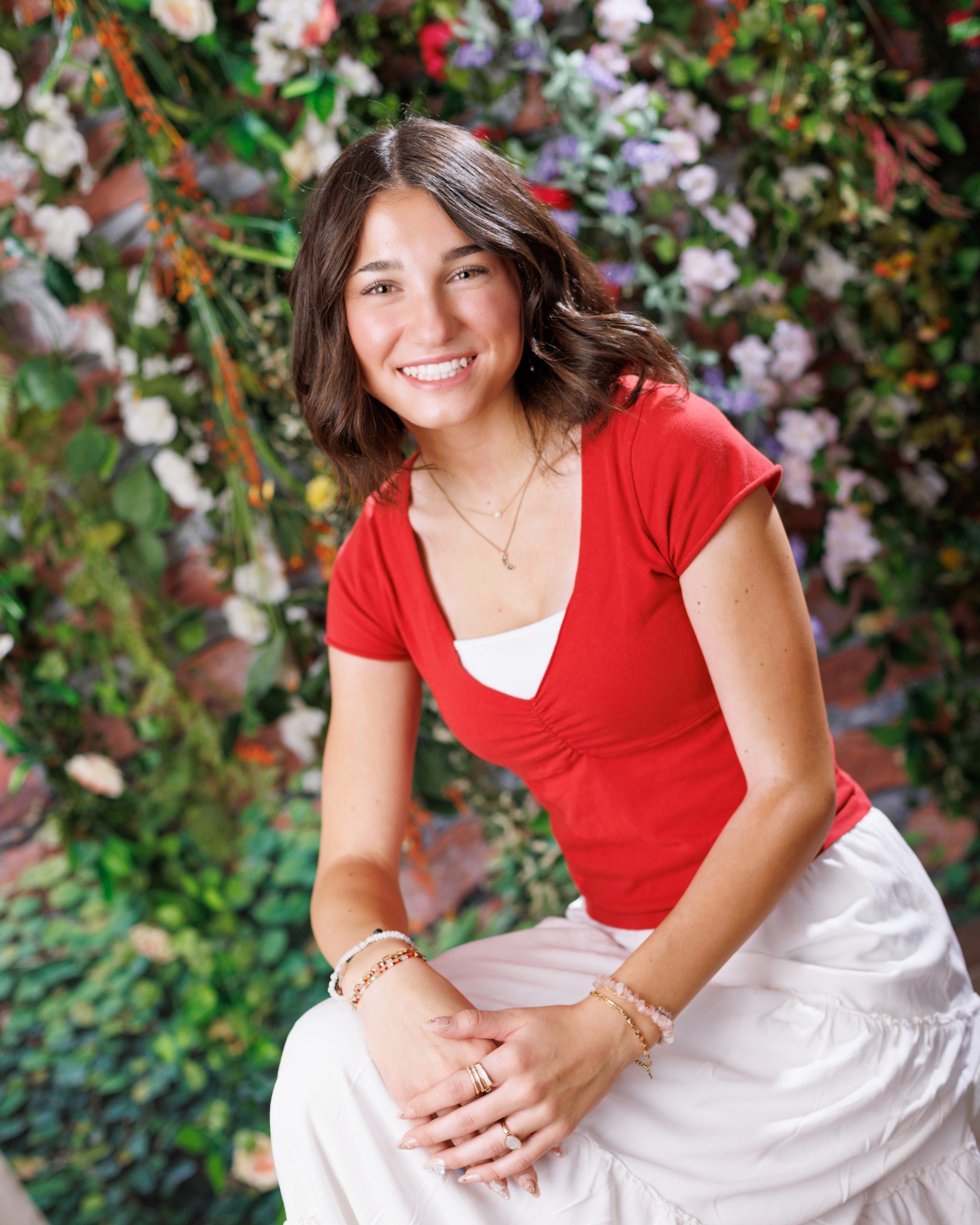 Anna posing in smocked peplum top with arched doorway backdrop at Woodhaven Senior Session