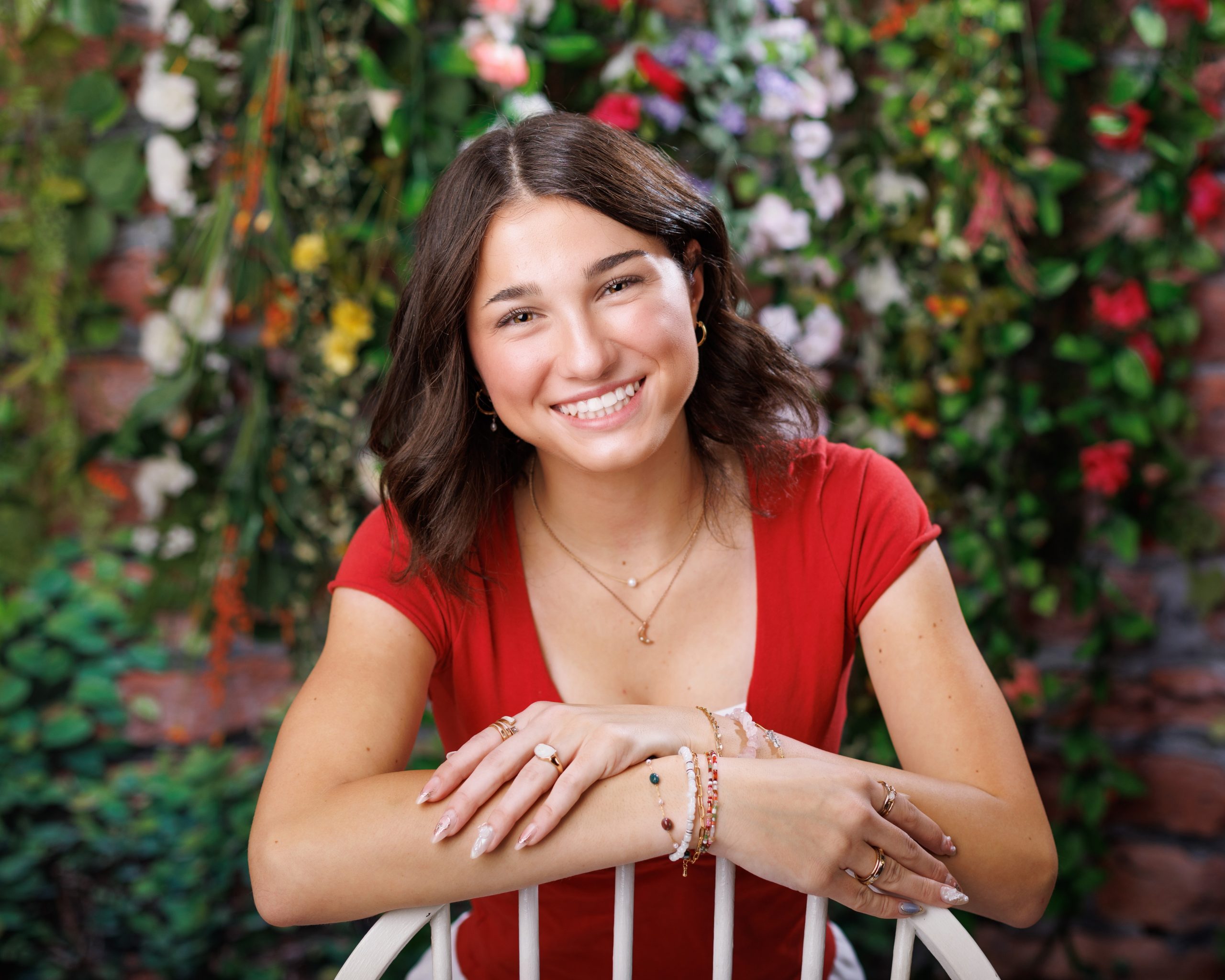 Anna posing in smocked peplum top with arched doorway backdrop at Woodhaven Senior Session