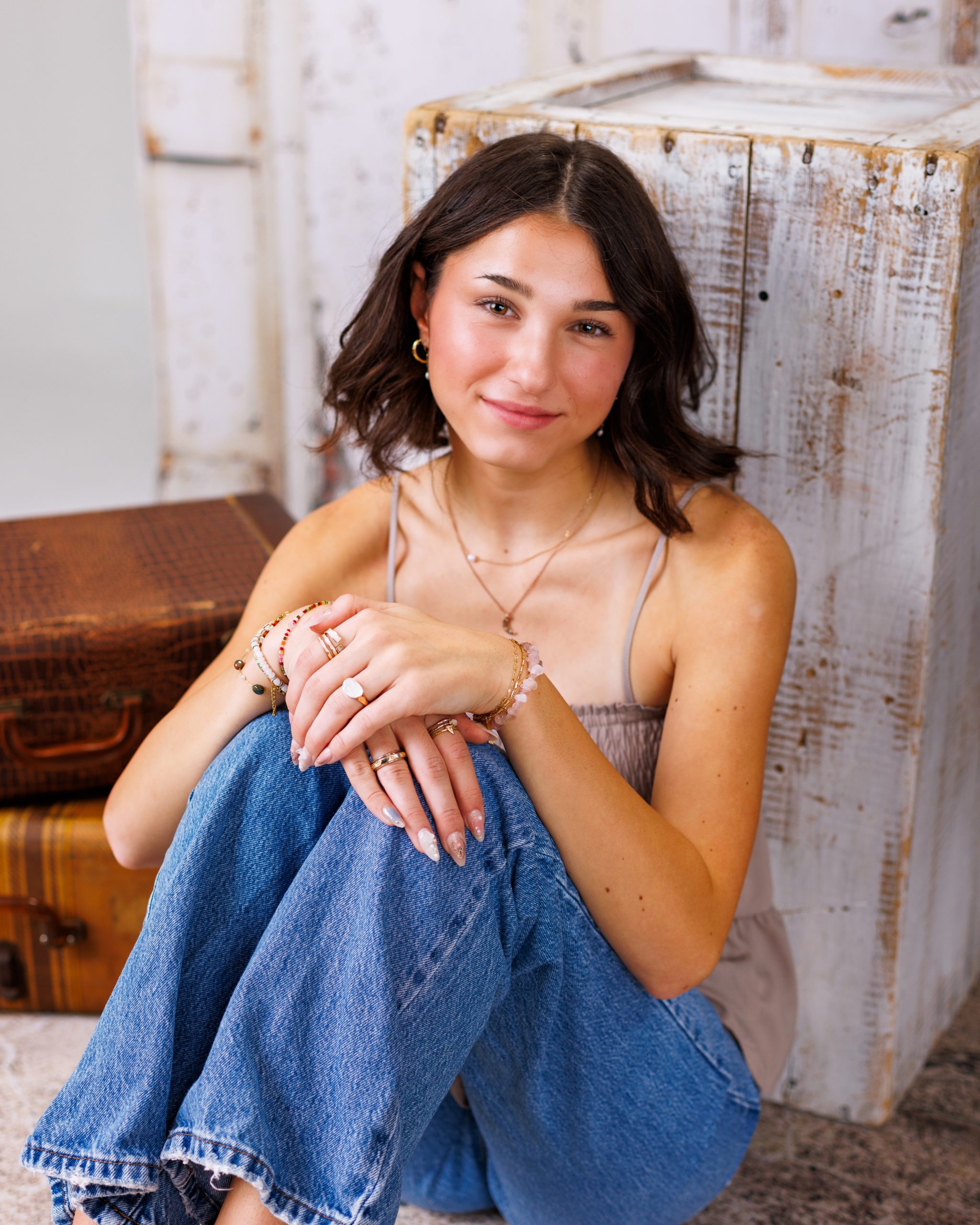 Anna posing in smocked peplum top with arched doorway backdrop at Woodhaven Senior Session
