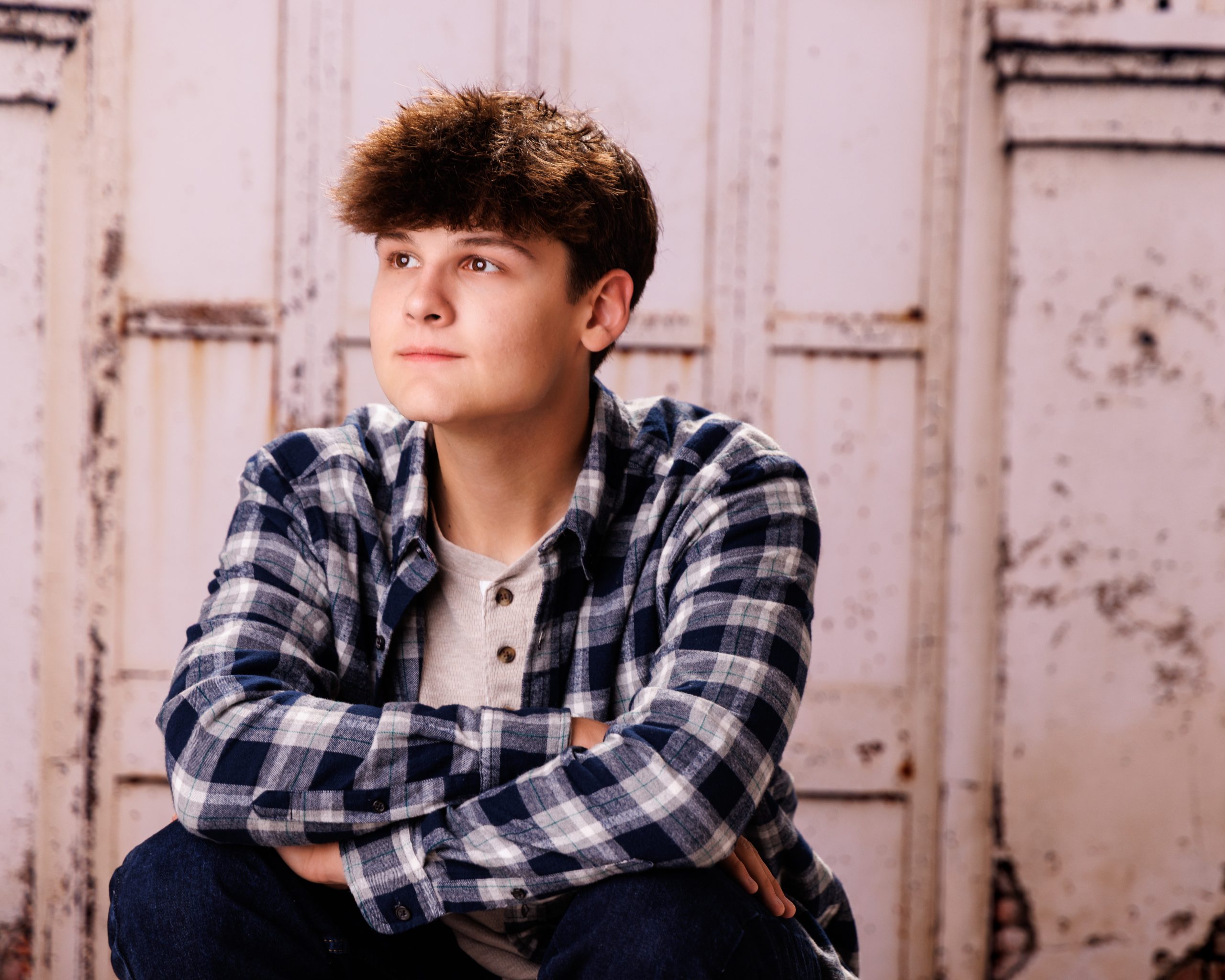 Andrew's contemplative pose for Downriver photography session with crossed arms