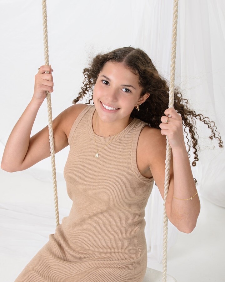 Girl on swing during senior photography session in Wyandotte