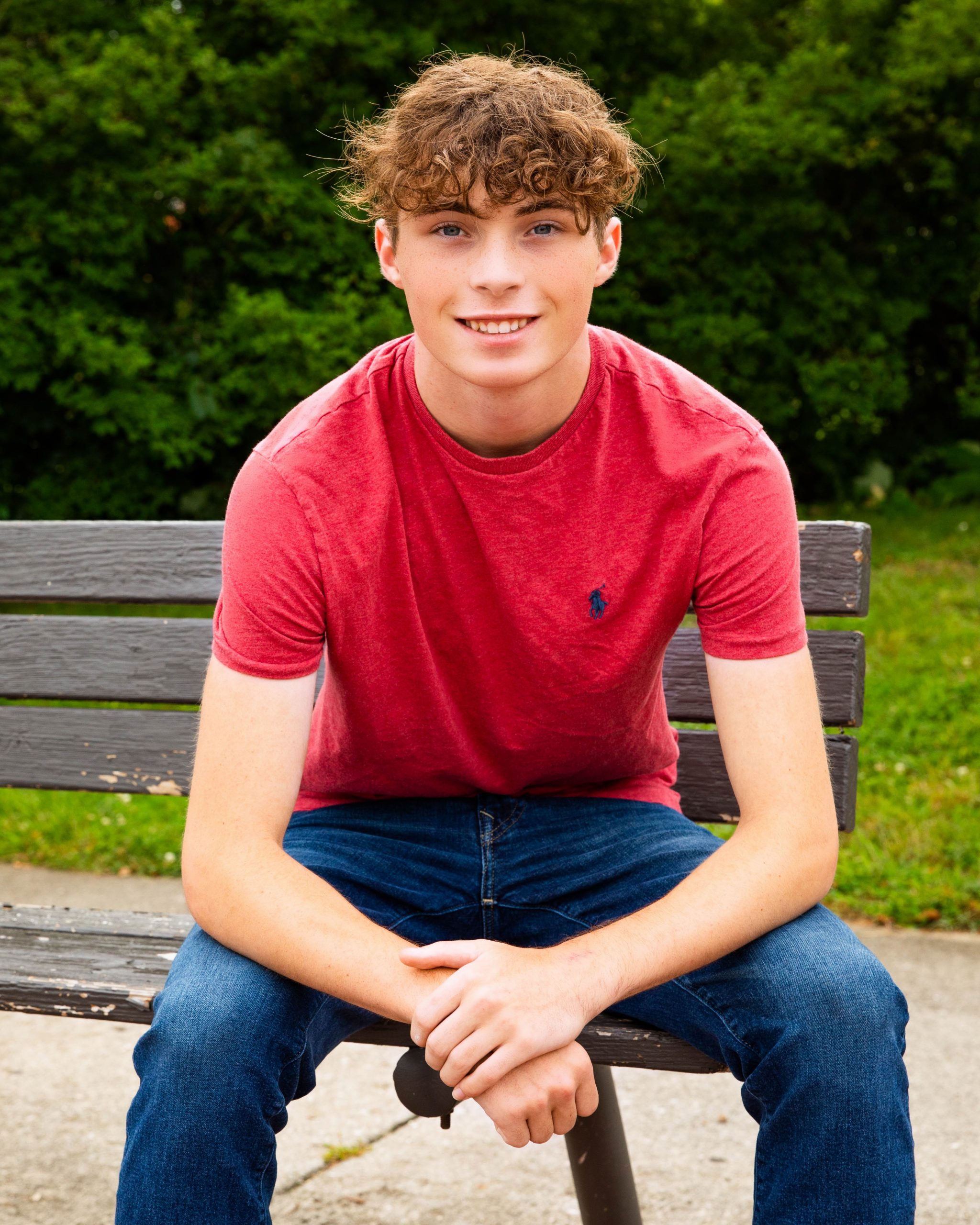 Michael seated on a bench near a restaurant storefront in Wyandotte