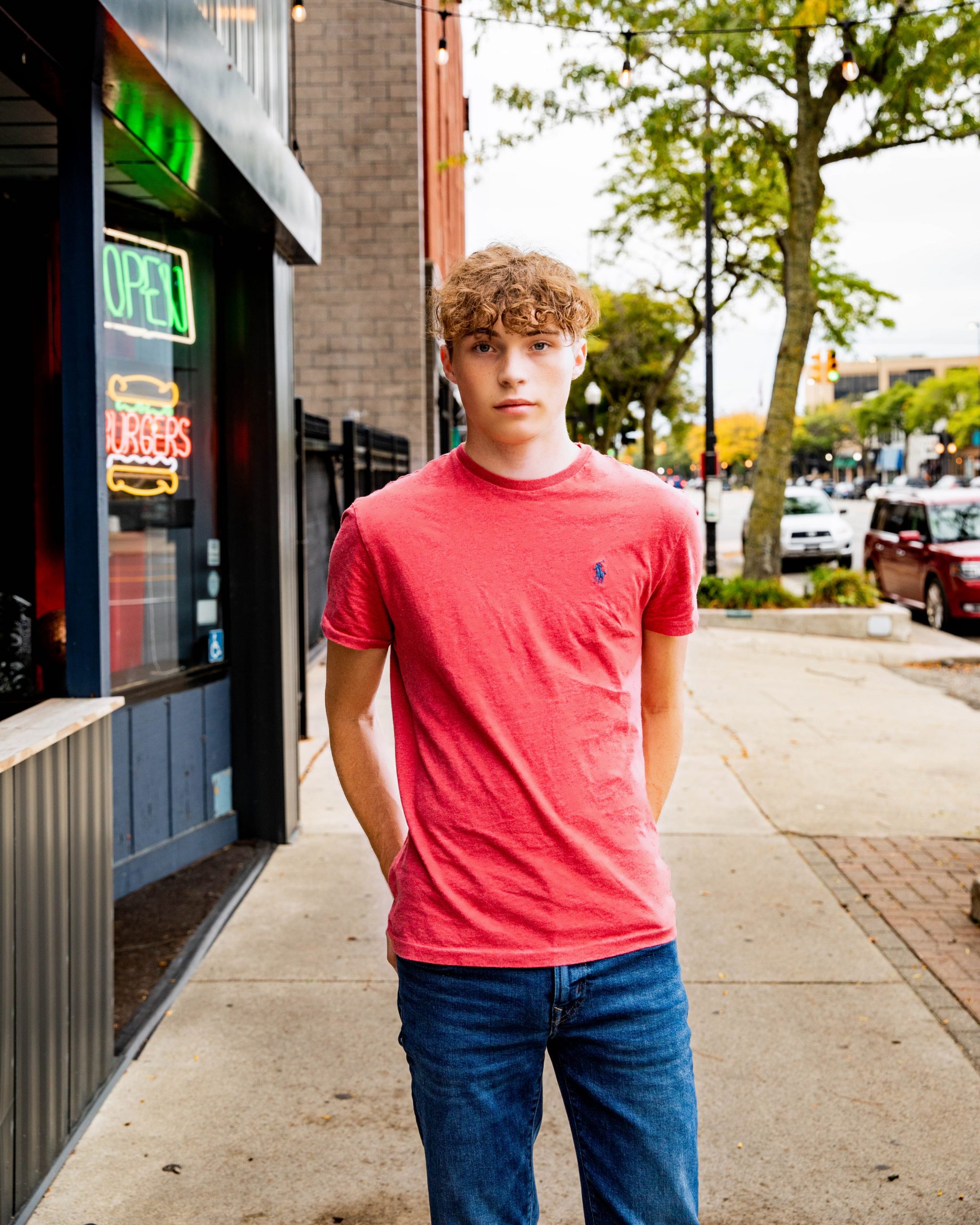 Michael seated on a bench near a restaurant storefront in Wyandotte