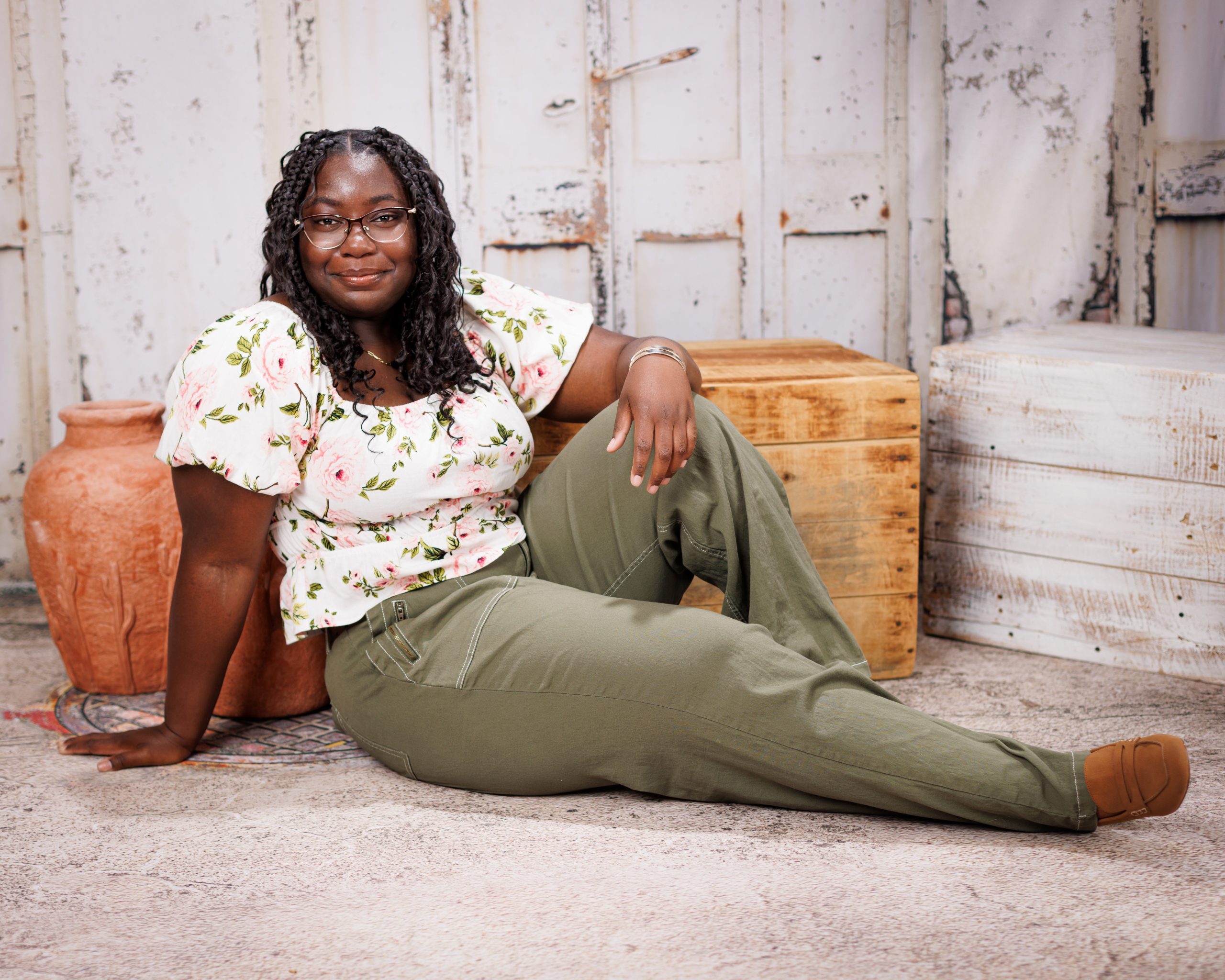 Wyandotte lifestyle photo of a woman sitting on floor with wooden box and pottery